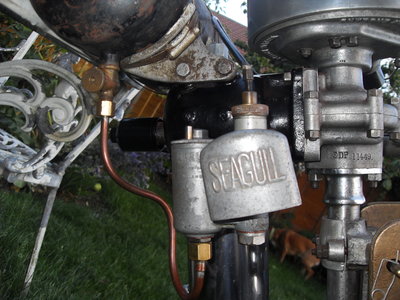this pic shows quite a lot. fuel pipe, carb,tank brackets, serial number, underside of the magneto.
